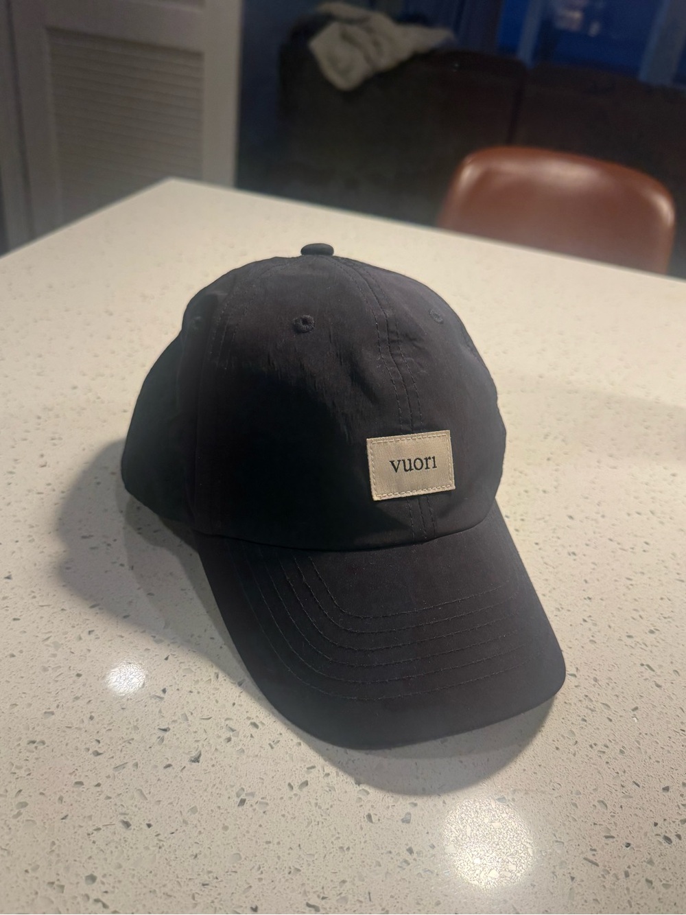 Vuori Black Cap with Cream Logo Patch